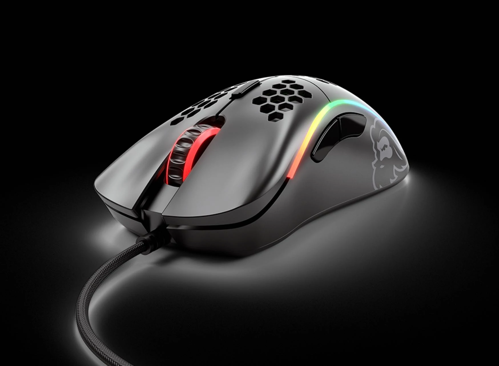 Glorious Model D RGB gaming mouse in matte black showing its ergonomic right-handed shape and honeycomb design