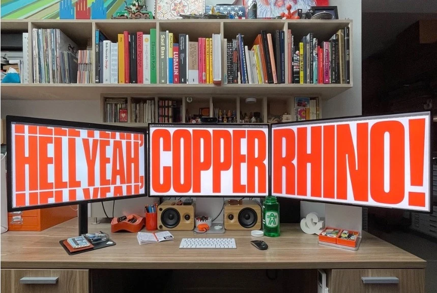 Aaron James Draplin's bold graphic design workspace featuring vintage posters, bold typography prints, and a curated collection of design artifacts