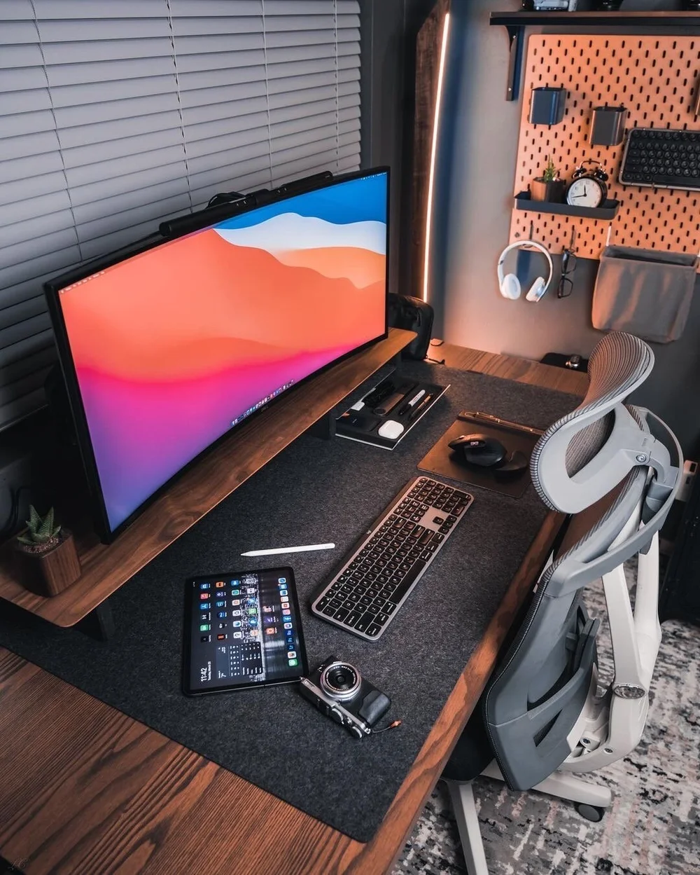 Lloyd Carig's walnut floor lamp and vintage chest beside his desk in his Vancouver setup