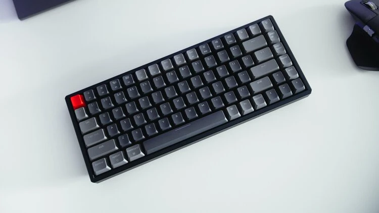 Keychron K2 v2 75% mechanical keyboard on a desk showing its compact layout and backlit keycaps