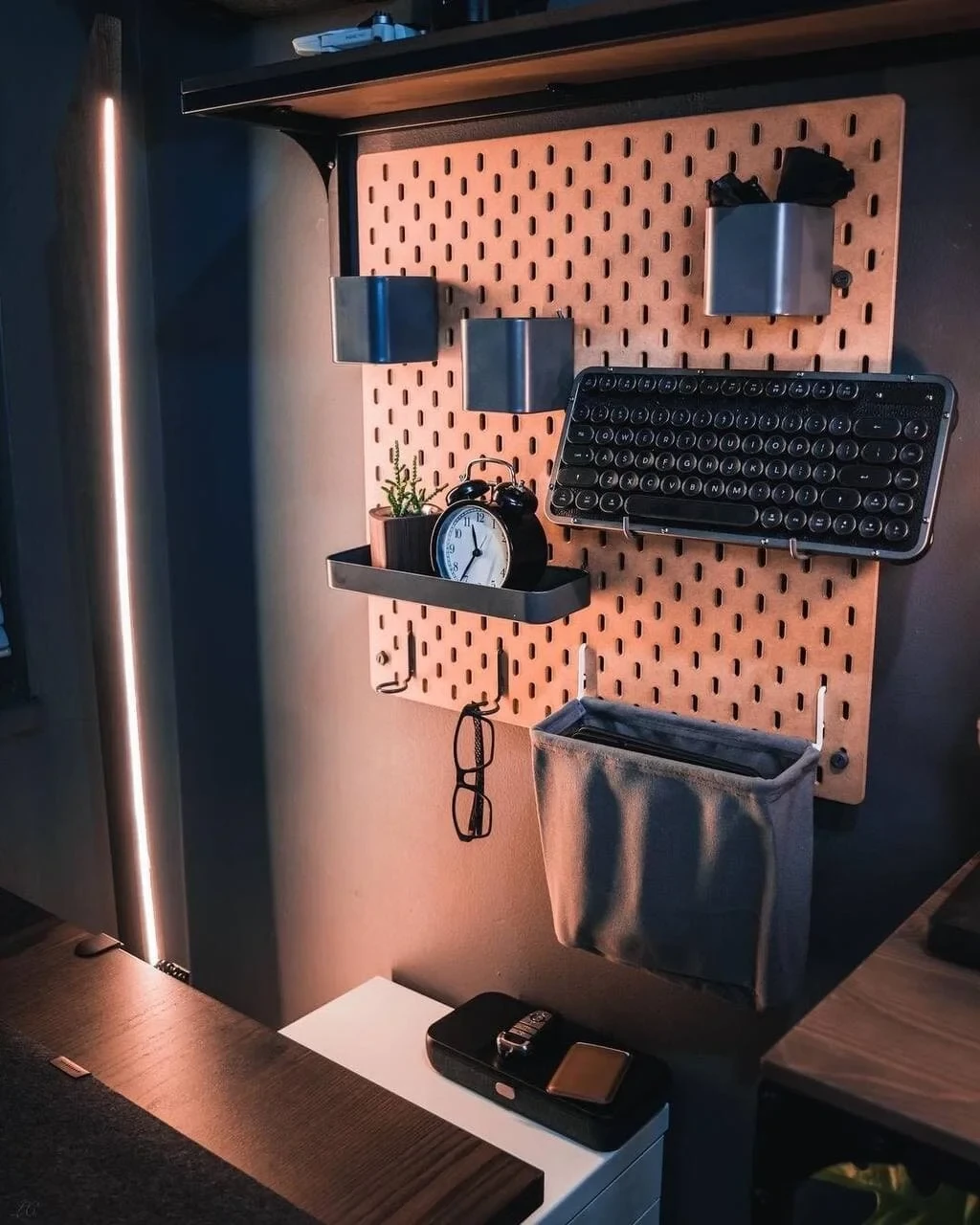 Lloyd Carig's IKEA Skadis pegboard with shelves, keyboard holder, and LED strip lighting in his Vancouver desk setup